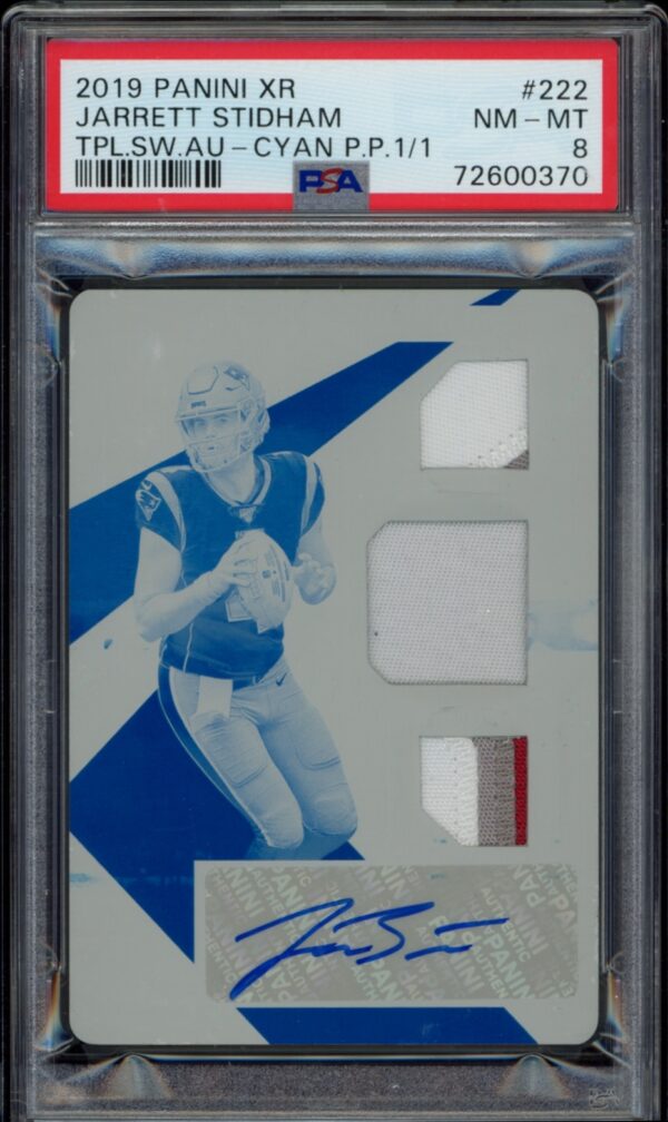 2019 Panini XR Jarrett Stidham autographed card featuring triple swatches and cyan print.