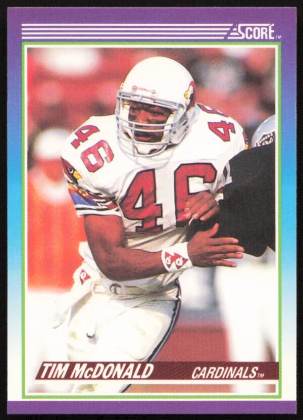 Front view of 1990 Score Tim McDonald Football Card #127 featuring him in action.