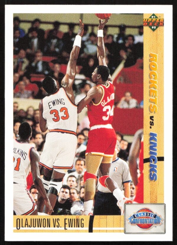 1991 Upper Deck basketball card of Hakeem Olajuwon vs. Patrick Ewing in action.