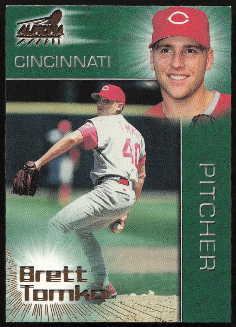 Brett Tomko pitching, 1998 Pacific Aurora baseball card, vibrant background, collectors item.