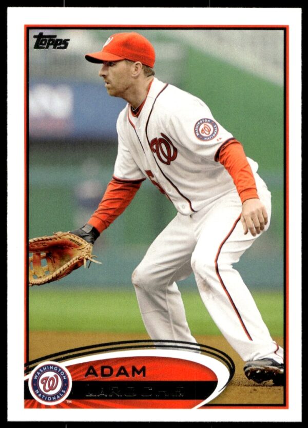 2012 Topps card of Adam LaRoche in Nationals uniform, mid-action pose, stadium backdrop.