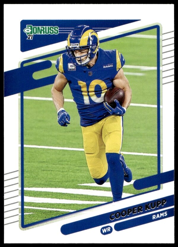 Front of 2021 Donruss Cooper Kupp Card #142 showcasing his athleticism in Rams uniform.