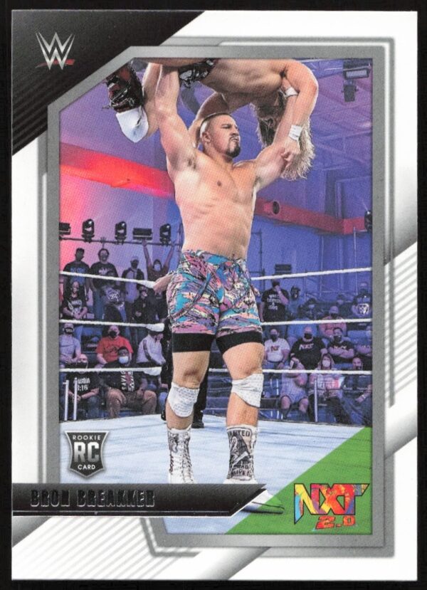 Bron Breakker celebrates WWE NXT victory on collectible card, holding championship belt high.