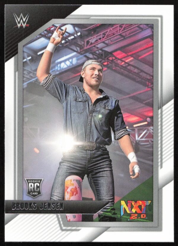 WWE NXT Rookie Card: Brooks Jensen in action inside the ring, energy-filled atmosphere.