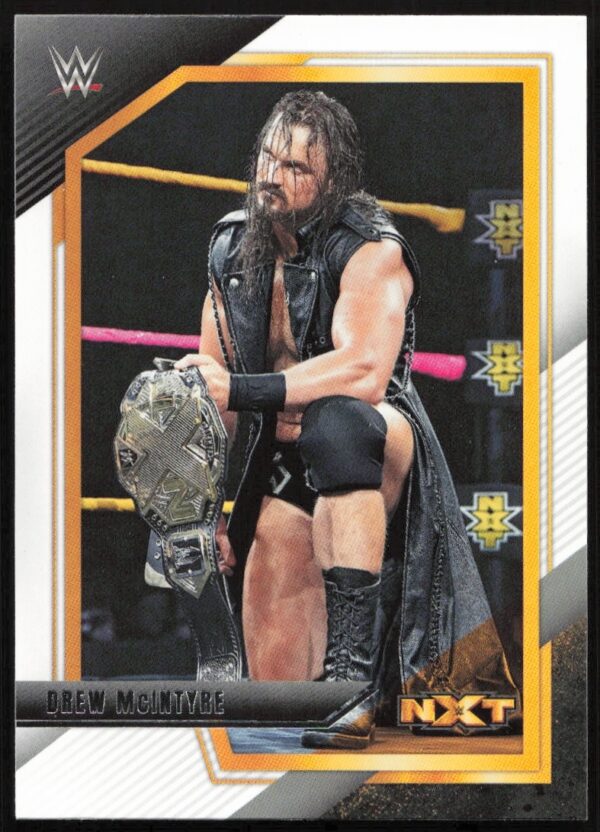 Drew McIntyre WWE NXT card featuring him with a championship belt in-ring.