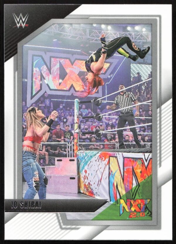 Io Shirai performs aerial move on WWE NXT action card with vibrant design and colors.