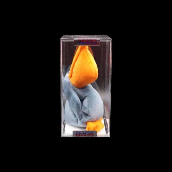 Artfully preserved orange peel sculpture in glass, vibrant against a black backdrop.