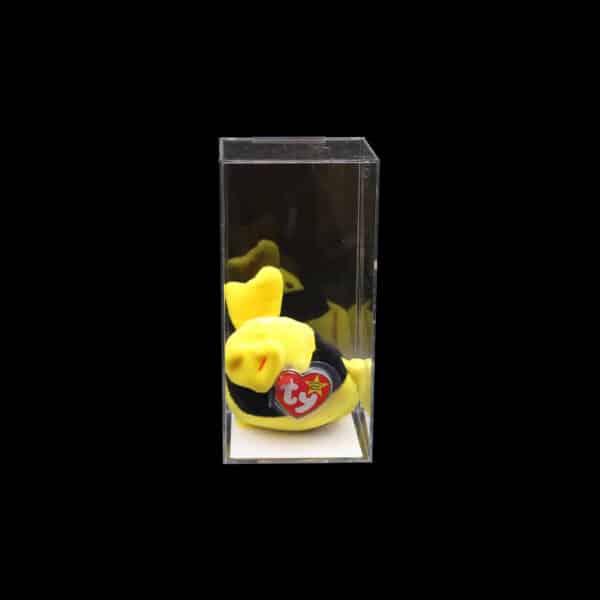 Miniature fruit art in clear display case featuring realistic banana and exotic fruit replicas.