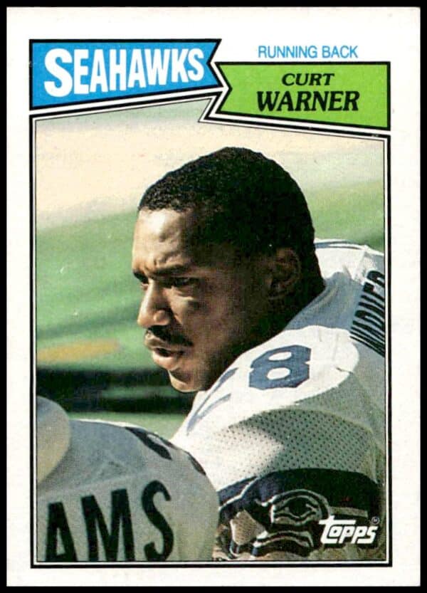 1987 Topps Curt Warner football card, #174, depicts him in action on the field.