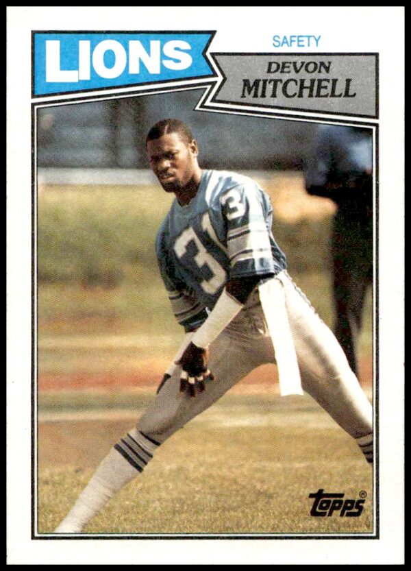 1987 Topps Devon Mitchell #327 football card featuring player in gear with vintage design.